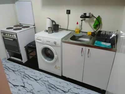a kitchen with a washing machine and a sink at Industrija in Belgrade