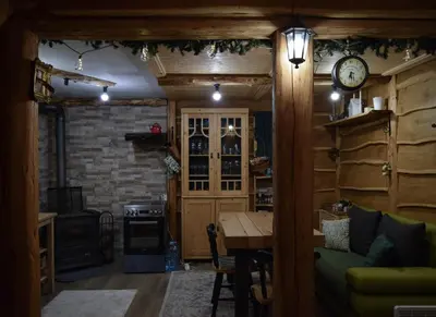 a living room with a clock on a brick wall at Zonamita house in Velika Remeta