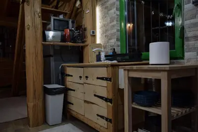 a kitchen with a wooden dresser and a counter at Zonamita house in Velika Remeta