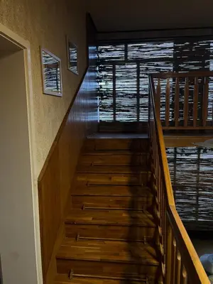 a staircase in a house with wooden floors andwindows at Royal castle Fruska gora in Prnjavor