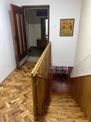 a hallway with wooden floors and a stair case at Royal castle Fruska gora in Prnjavor