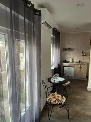 a room with a table and chairs and a kitchen at Royal castle Fruska gora in Prnjavor