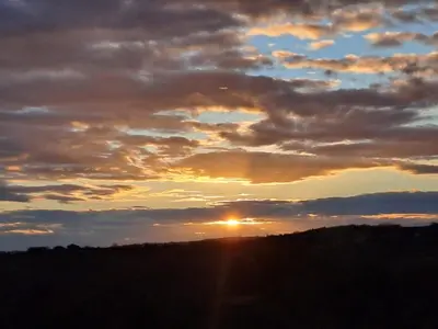 a sunset with the sun setting in the sky at Vino & Vista in Ripanj