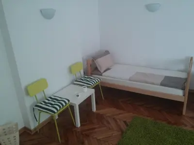 a small room with a couch and two chairs at Cricket 2 Hostel in Belgrade