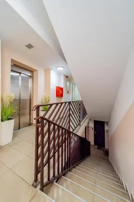 a staircase in a building with a stair case at Aqualux Apartment with garage in Belgrade