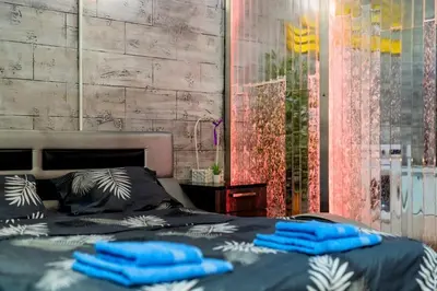 a bed with blue pillows on top of it at Aqualux Apartment with garage in Belgrade