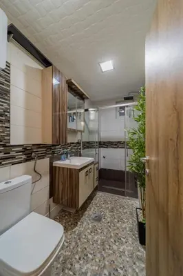 a bathroom with a toilet and a sink and a shower at Aqualux Apartment with garage in Belgrade