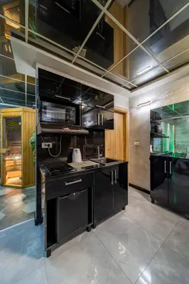 a kitchen with black cabinets and a stove at Aqualux Apartment with garage in Belgrade