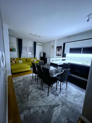 a living room with a table and chairs and a couch at PLEASURE LUX Bg in Belgrade