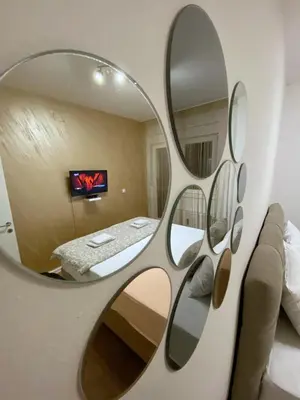 a mirror hanging on a wall in a room at PLEASURE LUX Bg in Belgrade