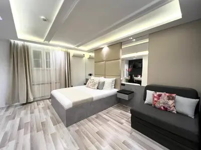 a bedroom with a bed and a couch at Hotel Forever in Belgrade