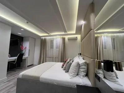 a bedroom with a large bed and a piano at Hotel Forever in Belgrade
