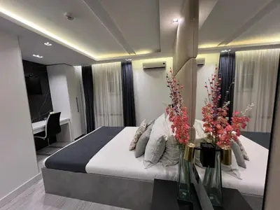 a bedroom with a large bed with flowers on it at Hotel Forever in Belgrade