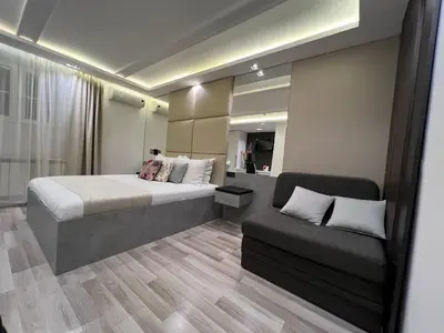 a hotel room with a bed and a couch at Hotel Forever in Belgrade