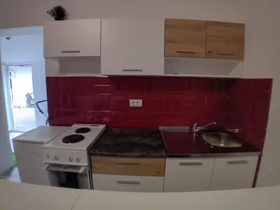 a kitchen with a stove and a sink at ALEJA park in Železnicka Stanica Inđija Selo