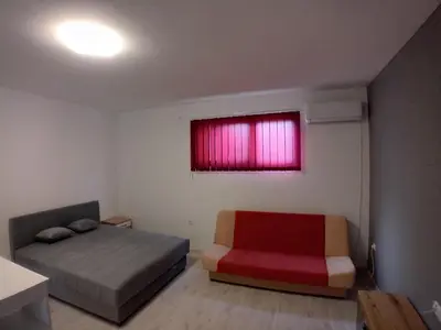 a bedroom with a bed and a red window at ALEJA park in Železnicka Stanica Inđija Selo