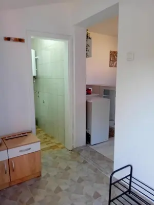 an empty room with a kitchen and a refrigerator at ALEJA park in Železnicka Stanica Inđija Selo