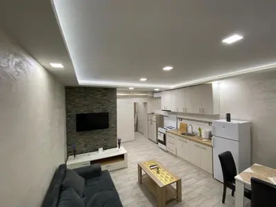 a living room with a couch and a kitchen at Daca 1 in Belgrade