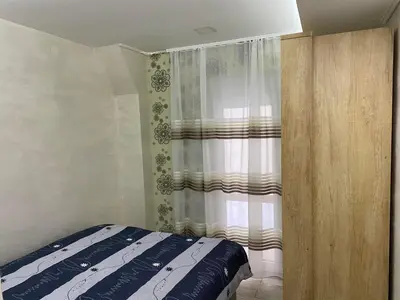 a bedroom with a bed and a curtain at Daca 1 in Belgrade