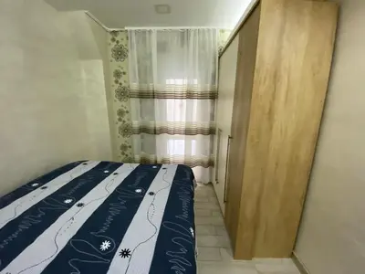a small bedroom with a bed and a window at Daca 1 in Belgrade