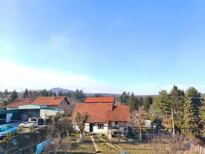 a house with red roofs and a parking lot at Muzej Accommodation in Repnica
