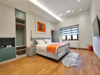 a large bedroom with a bed and a large window at Muzej Accommodation in Repnica