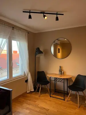 a dining room with a table and chairs and a mirror at City Centre Apartment 3 in Belgrade