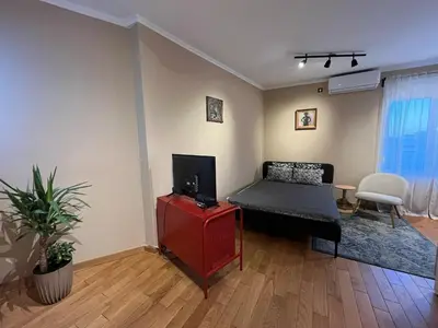 a living room with a bed and a tv at City Centre Apartment 3 in Belgrade