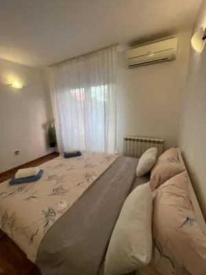 a large bed in a bedroom with a window at Manu in Belgrade