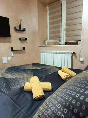 two yellow towels on a bed in a room at Rustic central in Belgrade