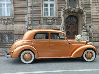 an orange car parked in front of a building at Rustic central in Belgrade