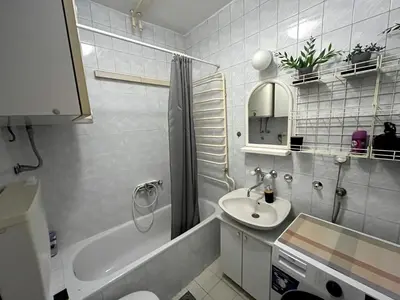 a bathroom with a sink and a tub and a toilet at Arena view in Belgrade