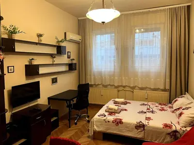 a bedroom with a bed and a desk and a computer at Arena view in Belgrade