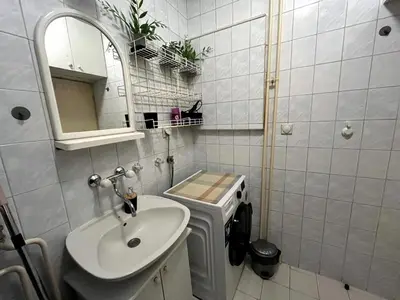 a white bathroom with a sink and a mirror at Arena view in Belgrade