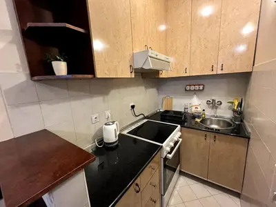 a small kitchen with a sink and a stove at Arena view in Belgrade