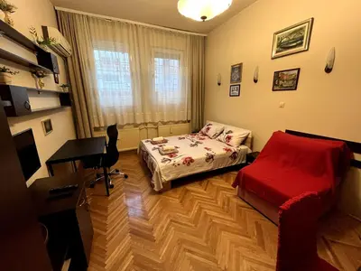 a small bedroom with a bed and a desk and a desk at Arena view in Belgrade