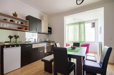 a kitchen with a table and chairs in a kitchen at 12 Beds 4 Baths 2 Renovated Apts 2nd & 3rd Flr in Belgrade