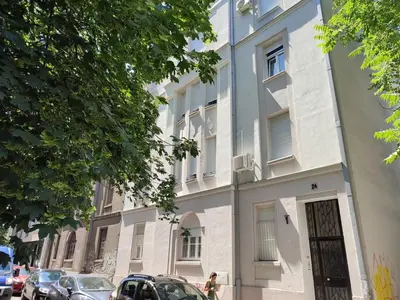 a building on a street with cars parked in front of it at 12 Beds 4 Baths 2 Renovated Apts 2nd & 3rd Flr in Belgrade