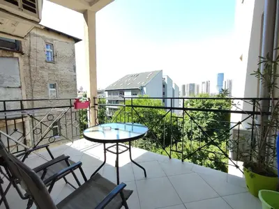 a patio with a table and chairs on a balcony at 12 Beds 4 Baths 2 Renovated Apts 2nd & 3rd Flr in Belgrade