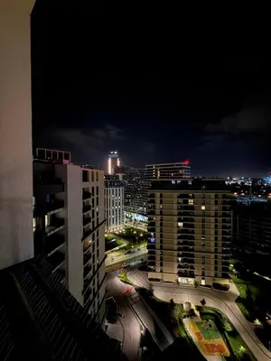 a view of a city skyline at night at Penthouse with River View BW in Belgrade