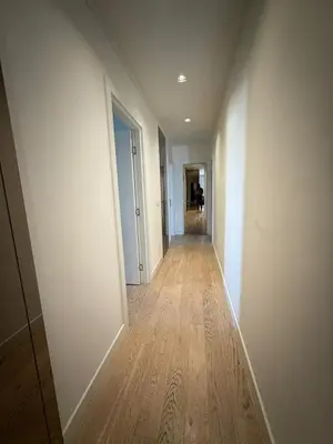 an empty hallway with white walls and a wooden floor at Penthouse with River View BW in Belgrade
