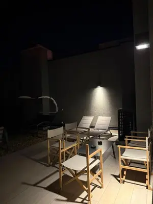 a group of chairs and tables in a dark room at Penthouse with River View BW in Belgrade