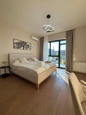 a bedroom with a large bed and a large window at Beograd na vodi - Belgrade Waterfront Apartments in Belgrade