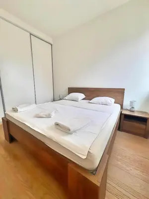 a bedroom with a large bed with white sheets at Beograd na vodi - Belgrade Waterfront Apartments in Belgrade