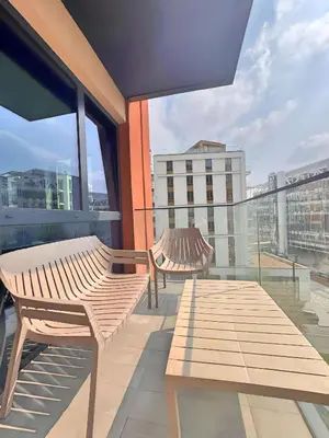 two benches on a balcony with a view of a city at Beograd na vodi - Belgrade Waterfront Apartments in Belgrade