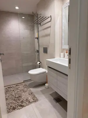 a bathroom with a toilet and a sink and a shower at Beograd na vodi - Belgrade Waterfront Apartments in Belgrade