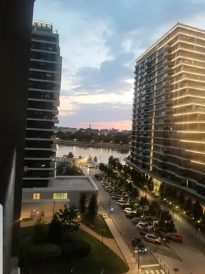 a view of a city with a large building and a parking lot at Beograd na vodi - Belgrade Waterfront Iris Apartment in Belgrade