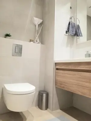 a white bathroom with a toilet and a sink at Beograd na vodi - Belgrade Waterfront Iris Apartment in Belgrade
