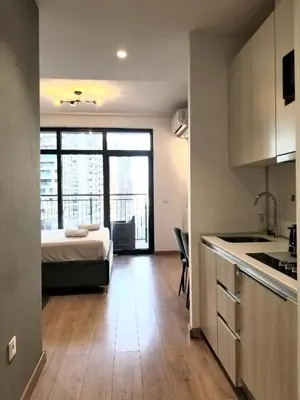a kitchen and a bedroom with a bed in a room at Beograd na vodi - Belgrade Waterfront Iris Apartment in Belgrade