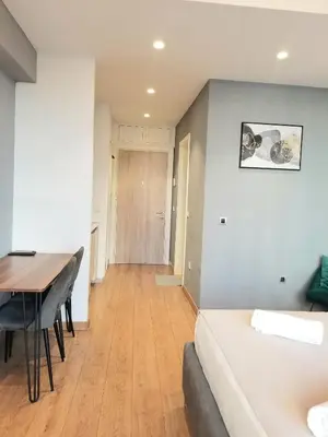 a room with a bed and a table and a dining room at Beograd na vodi - Belgrade Waterfront Iris Apartment in Belgrade
